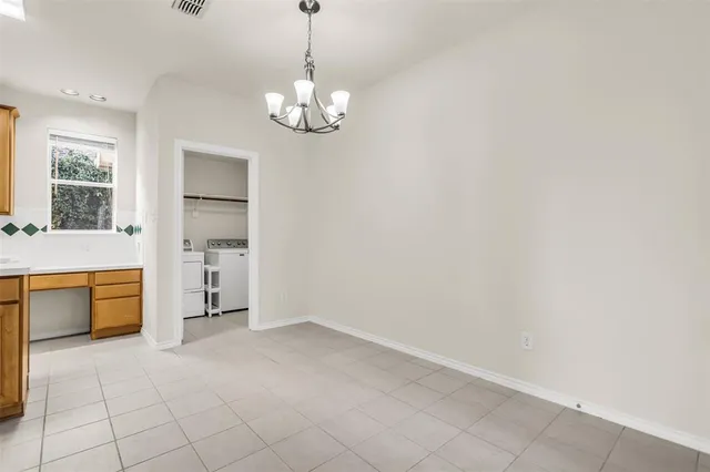 a view of a kitchen with a sink and dishwasher cabinet with a dining table