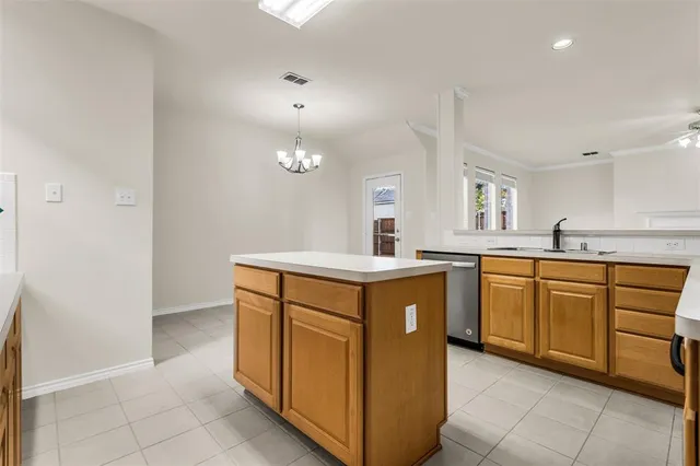 a kitchen with sink a stove and cabinets