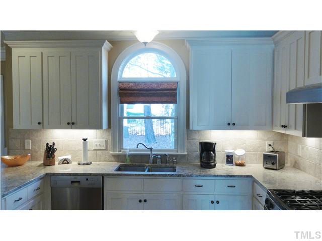 3706 Congeniality Way Raleigh, NC 27613 - Photo 3 of 10 a kitchen with a sink window and cabinets