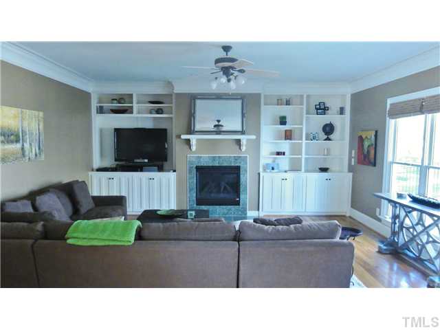 3706 Congeniality Way Raleigh, NC 27613 - Photo 4 of 10 a living room with furniture a fireplace and a flat screen tv