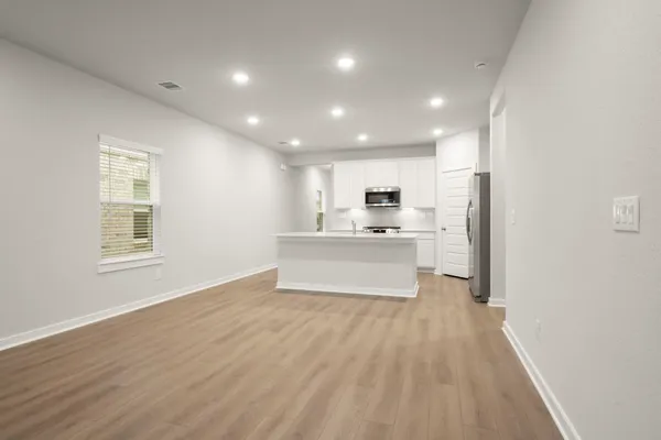 a view of kitchen with stainless steel appliances refrigerator oven and cabinets