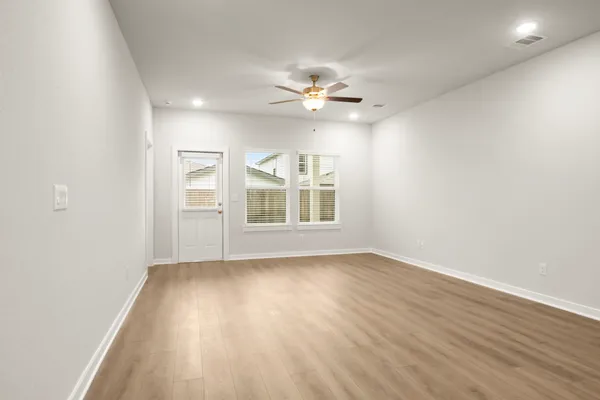 wooden floor in an empty room with a window