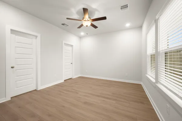 wooden floor in an empty room with a window
