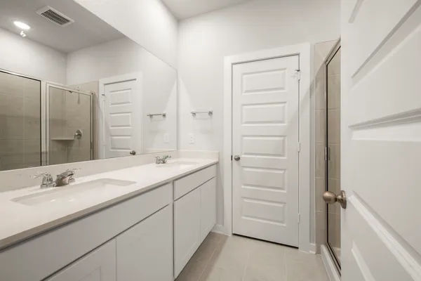 a bathroom with a double vanity sink and a mirror