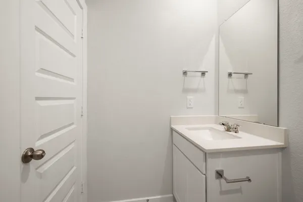 a bathroom with a sink a vanity and a mirror