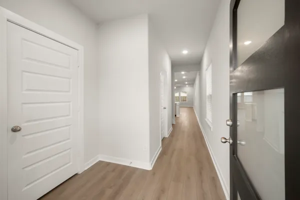 a view of a hallway with wooden floor