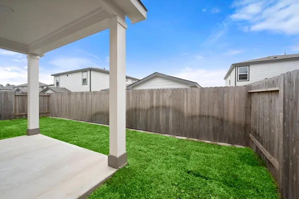 a view of a backyard with wooden fence