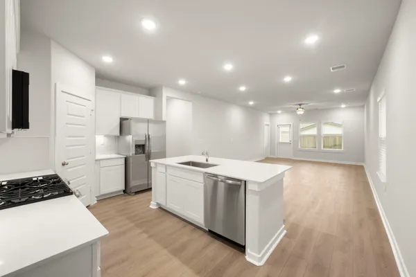 a kitchen with a stove a refrigerator and a sink