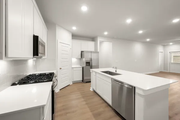 a kitchen that has a sink and a stove in it
