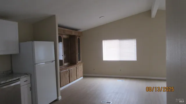 a kitchen with stainless steel appliances a refrigerator and a stove