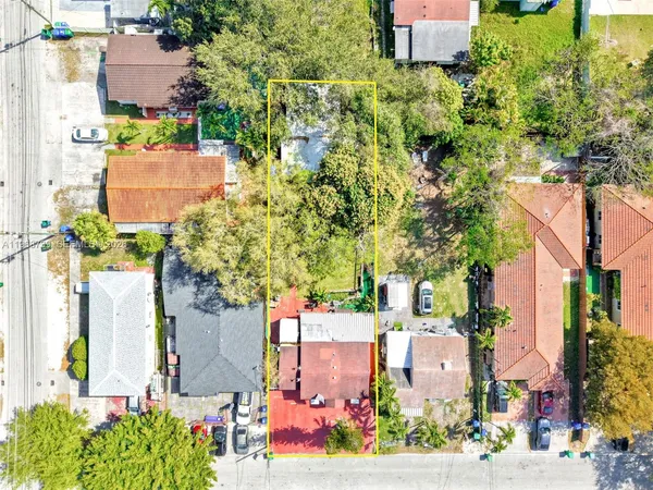 an aerial view of residential houses with outdoor space and street view