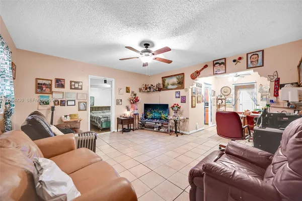 a living room with furniture a fireplace and a large window