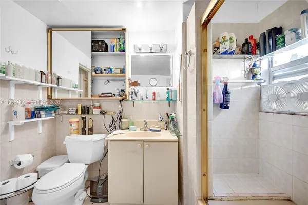 a bathroom with a sink a toilet and a shower