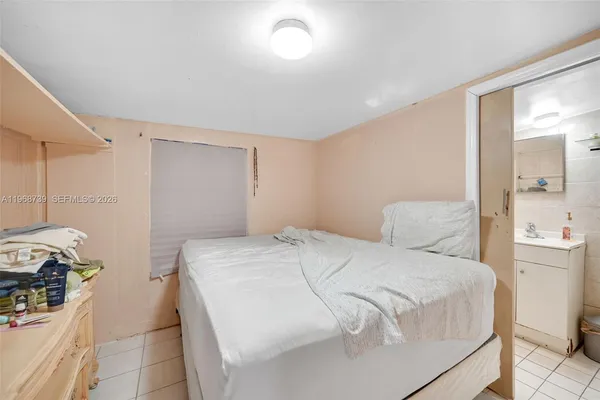 a bedroom with a bed and a mirror
