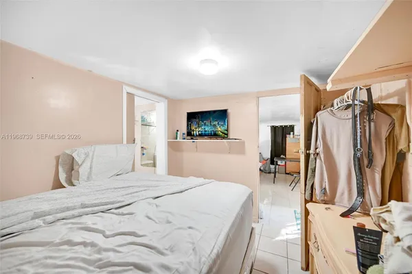 a bedroom with a bed and a flat screen tv