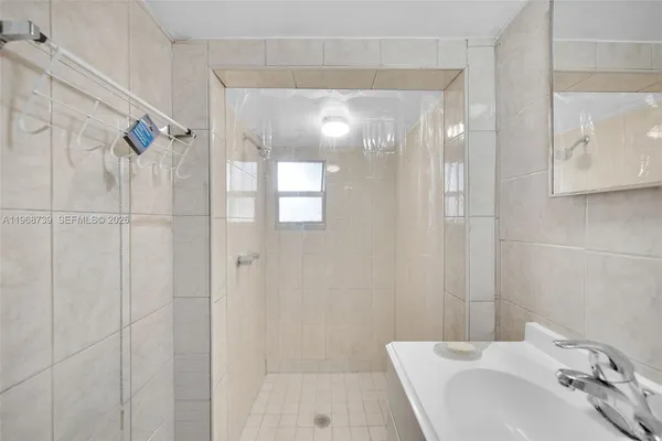 a bathroom with a sink and shower