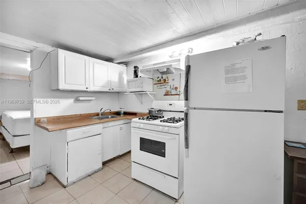 a kitchen with cabinets appliances and a counter space