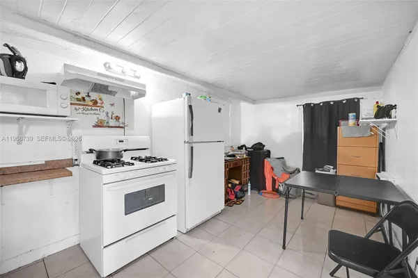 a kitchen with stainless steel appliances a stove a refrigerator and a refrigerator