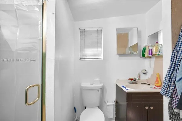 a bathroom with a sink toilet and mirror