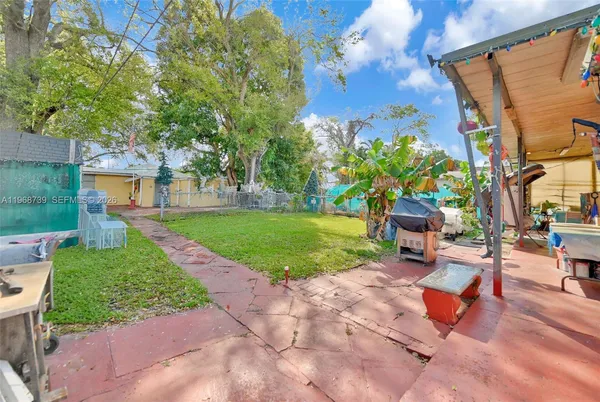 a view of a backyard with sitting area