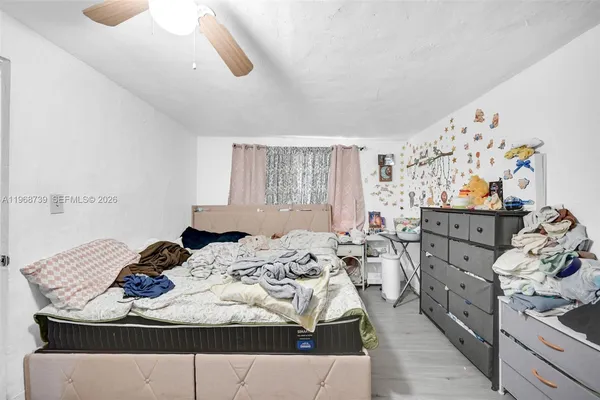 a bed sitting in a bedroom next to a window