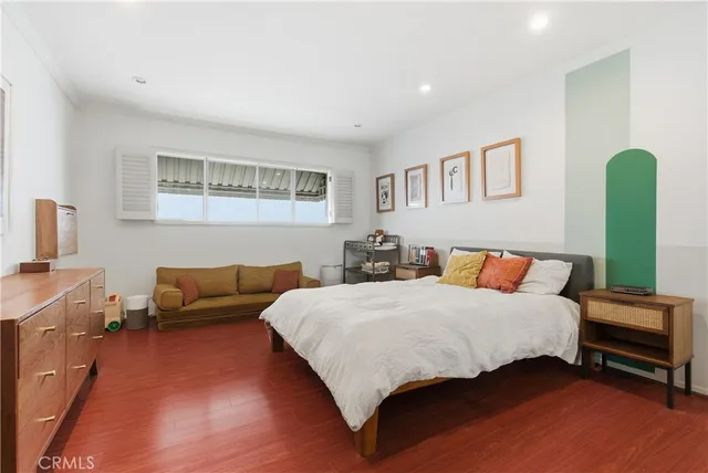 a bedroom with a bed and a couch