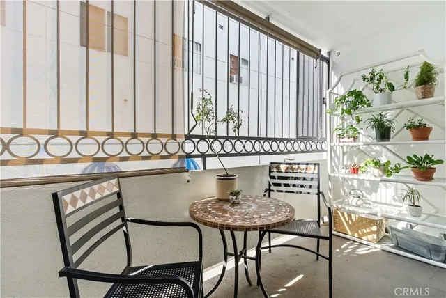 a view of a chairs and table in the balcony