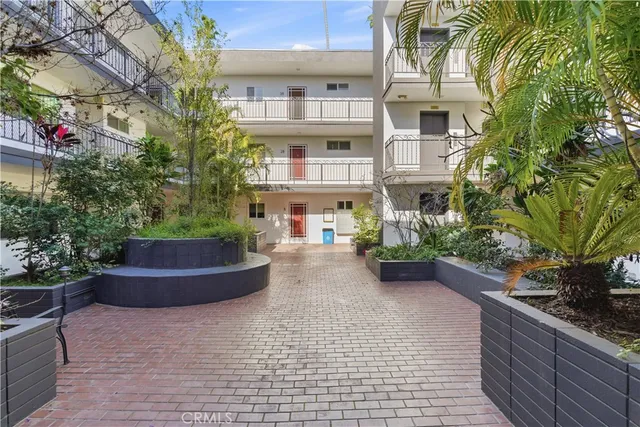 a view of a house with potted plants