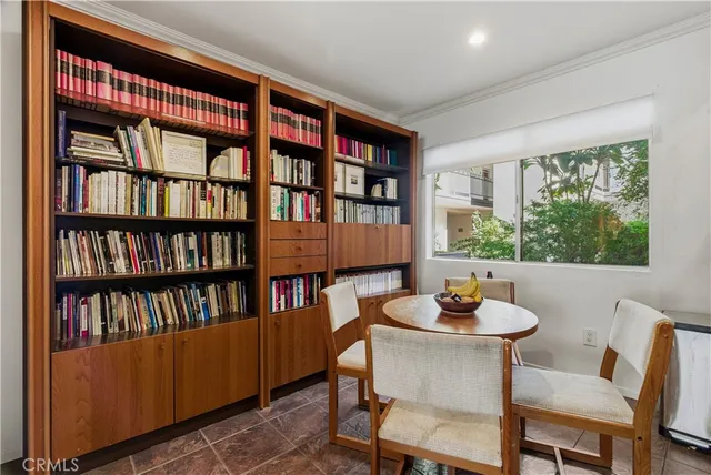 a work room with furniture and a book shelf