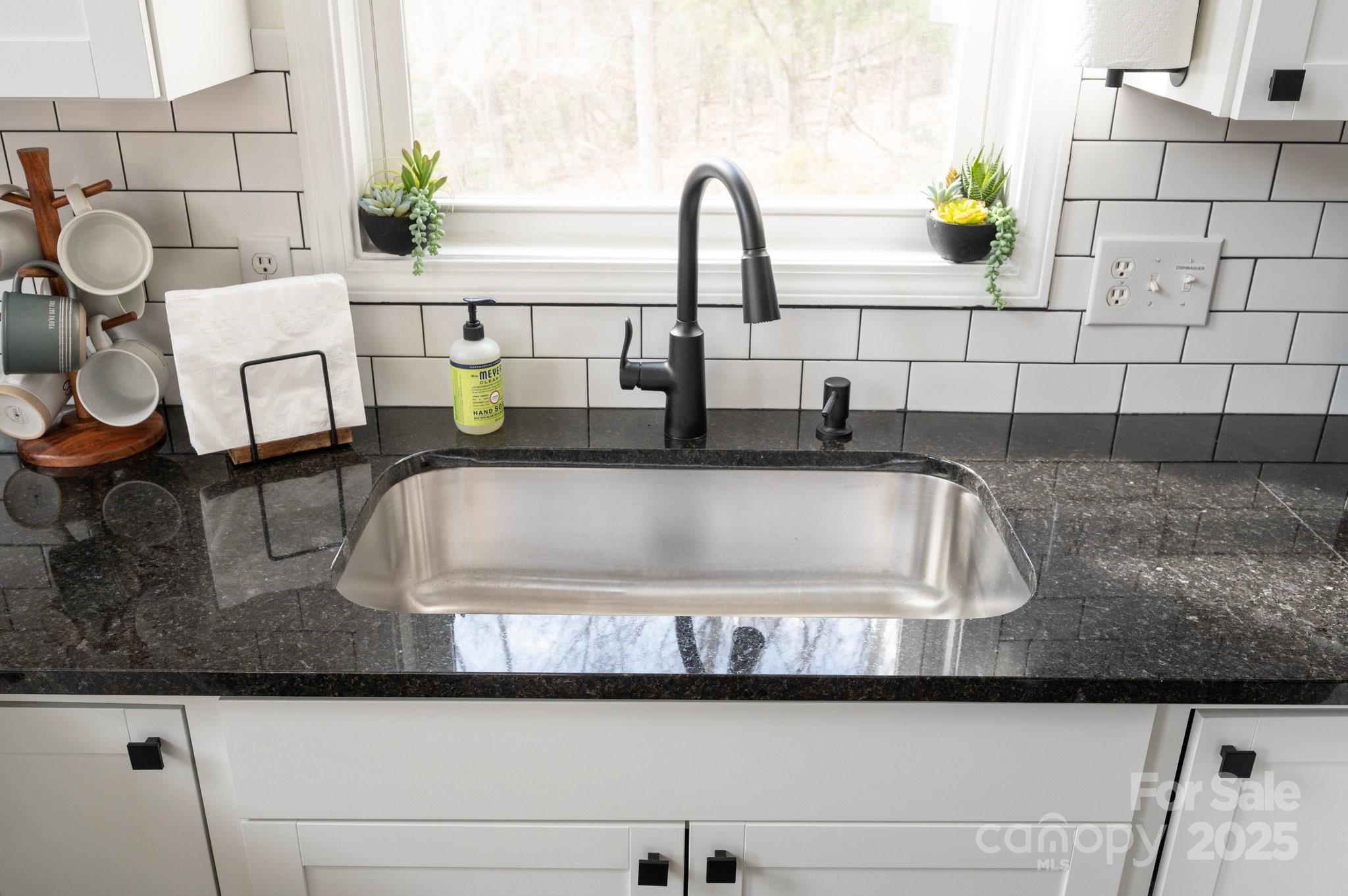 25 Lick Log Ridge Fairview, NC 28730 - Photo 11 of 34 a kitchen with a sink and a stove next to a window