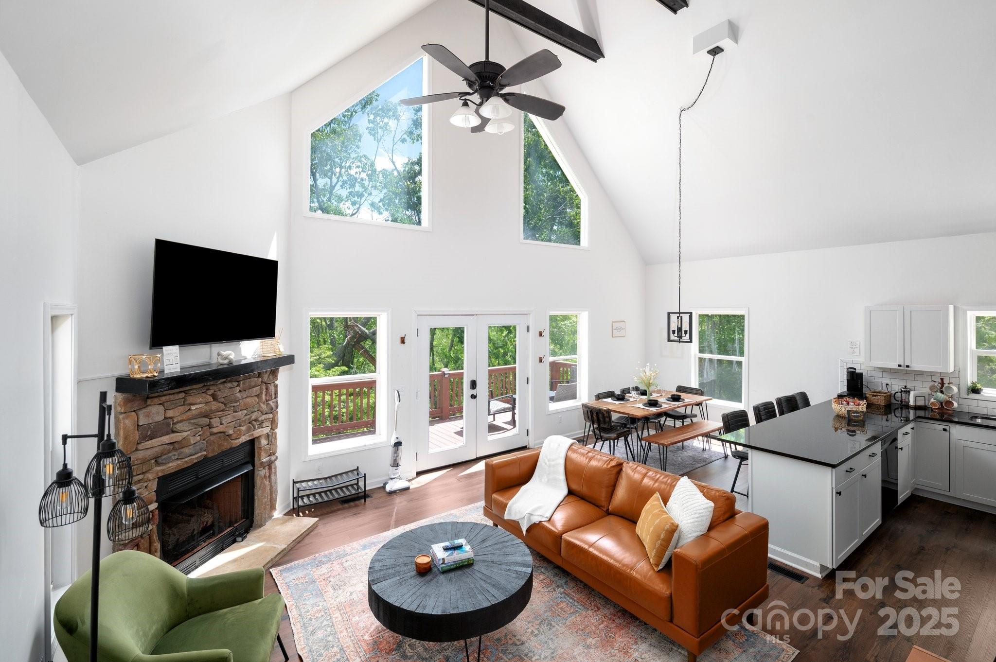 25 Lick Log Ridge Fairview, NC 28730 - Photo 13 of 34 a living room with fireplace furniture and a flat screen tv
