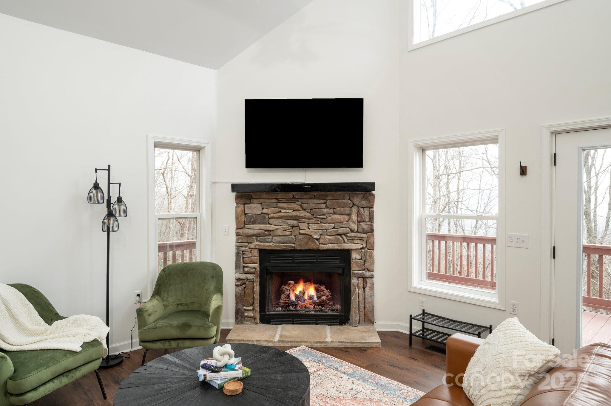 25 Lick Log Ridge Fairview, NC 28730 - Photo 15 of 34 a living room with furniture a flat screen tv and a fireplace