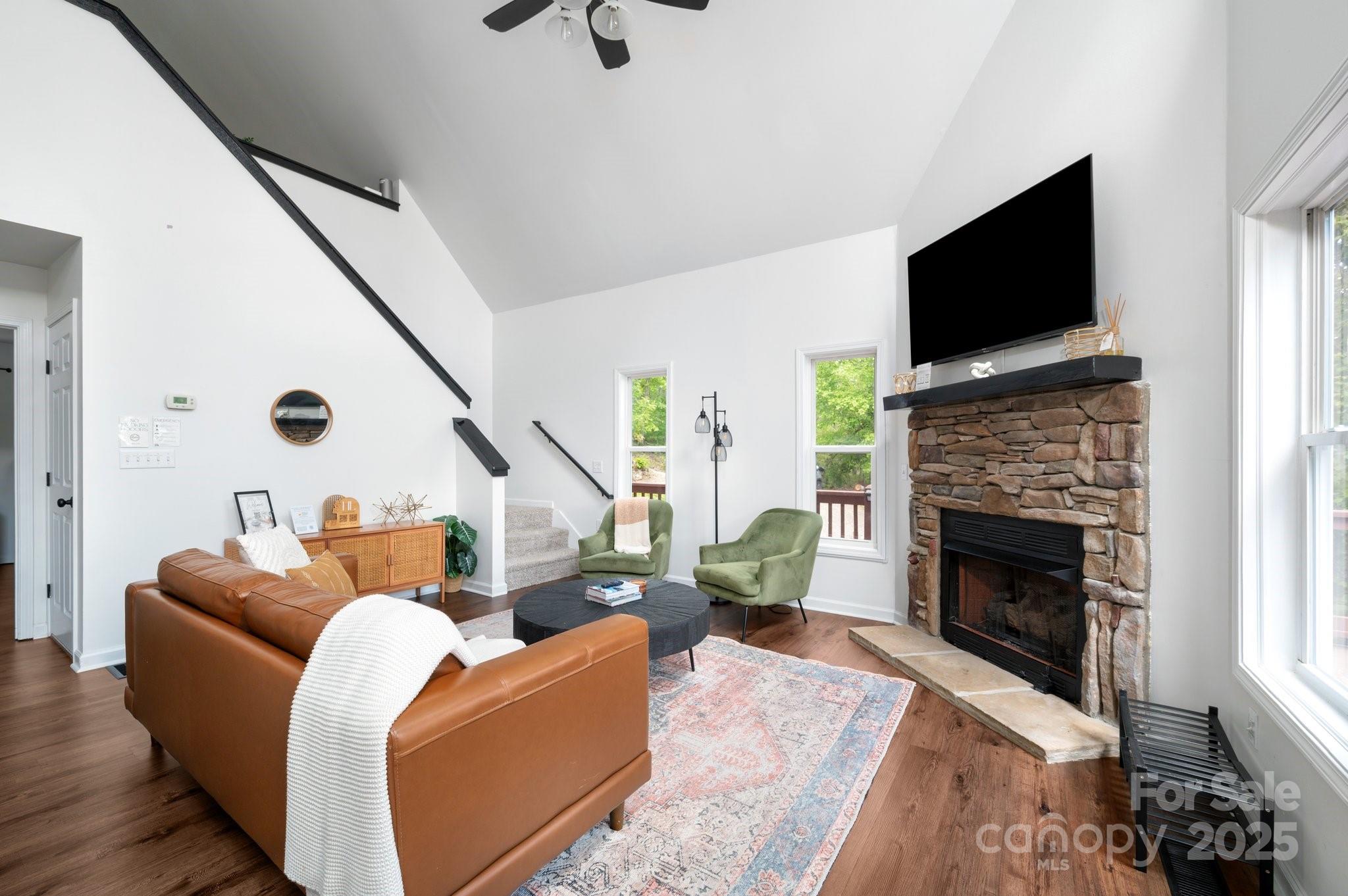 25 Lick Log Ridge Fairview, NC 28730 - Photo 20 of 34 a living room with furniture a flat screen tv and a fireplace