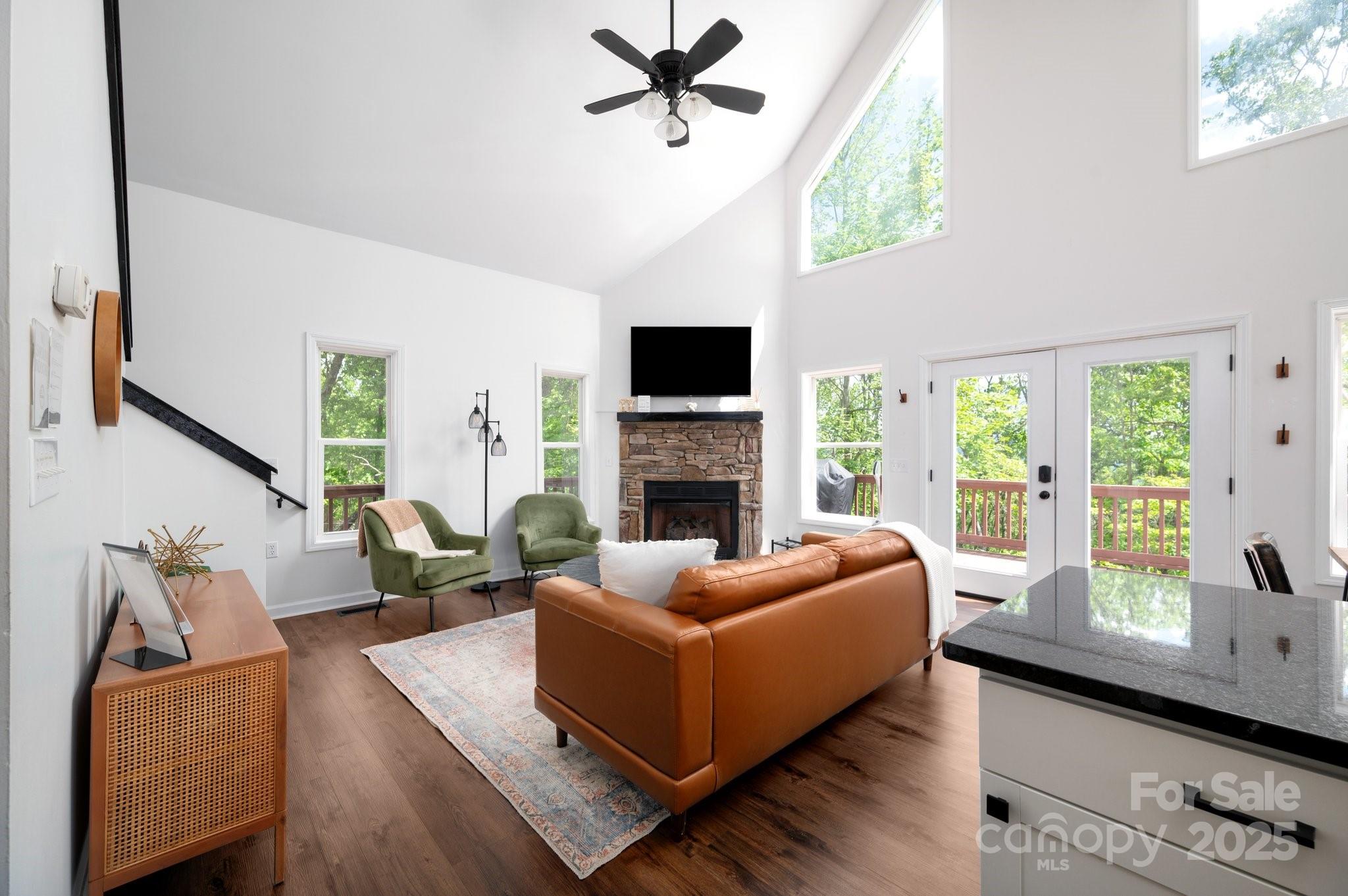 25 Lick Log Ridge Fairview, NC 28730 - Photo 23 of 34 a living room with furniture fireplace and flat screen tv