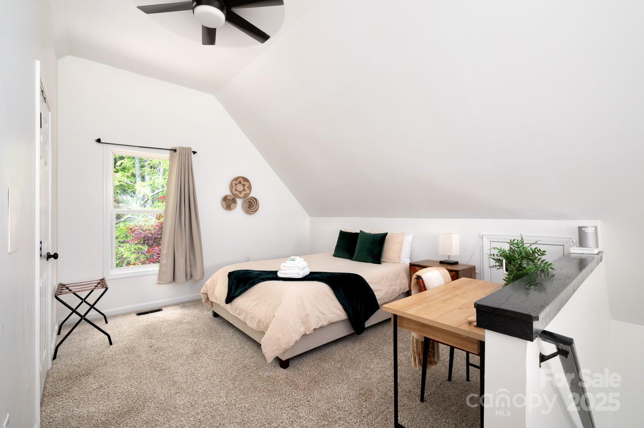 25 Lick Log Ridge Fairview, NC 28730 - Photo 27 of 34 a bedroom with furniture and a window