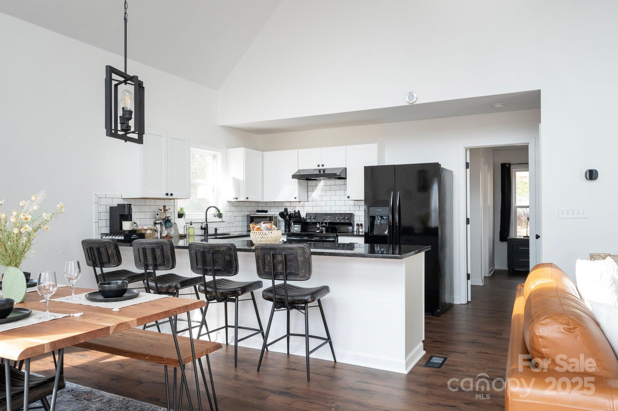 25 Lick Log Ridge Fairview, NC 28730 - Photo 9 of 34 a view of a dining room with furniture a kitchen and chandelier