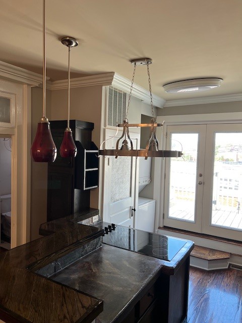 a kitchen with a table chairs and wooden floor
