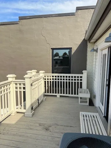 a view of a balcony with furniture