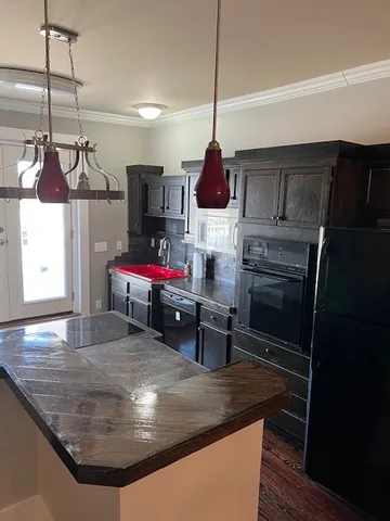 a kitchen with a stove a microwave and a table