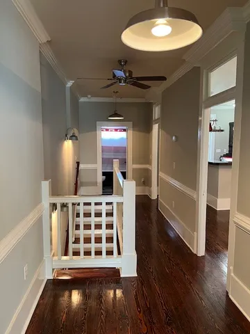 a view of a livingroom with wooden floor and furniture