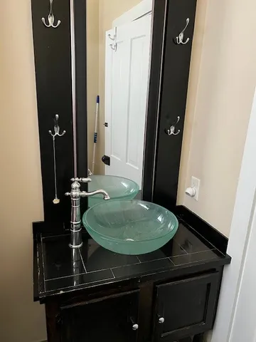 a bathroom with a sink a mirror and vanity