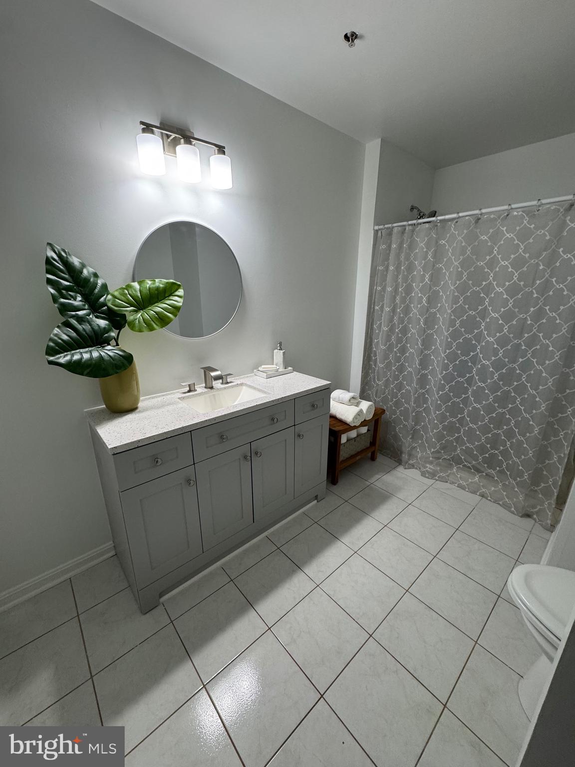 18310 Feathertree Way, Unit 101 Montgomery Village, MD 20886 - Photo 14 of 31 a bathroom with a sink and a mirror
