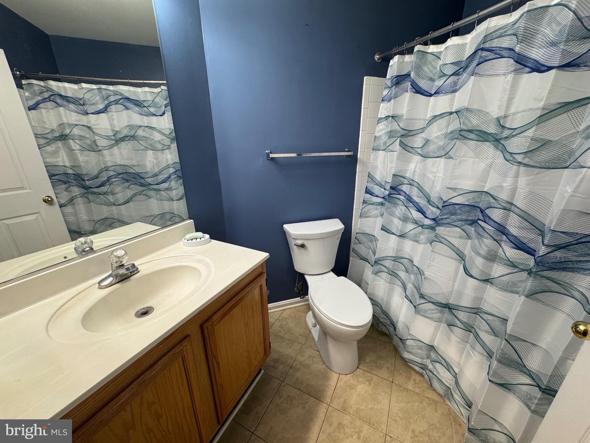18310 Feathertree Way, Unit 101 Montgomery Village, MD 20886 - Photo 17 of 31 a bathroom with a sink and a mirror