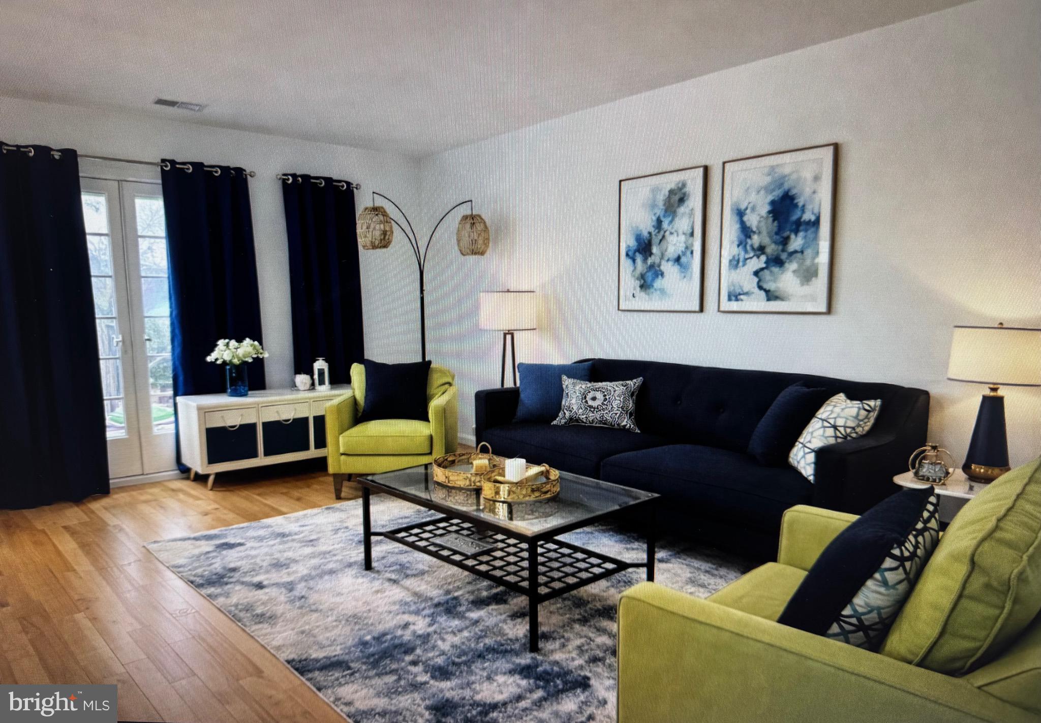 18310 Feathertree Way, Unit 101 Montgomery Village, MD 20886 - Photo 20 of 31 a living room with furniture and wooden floor
