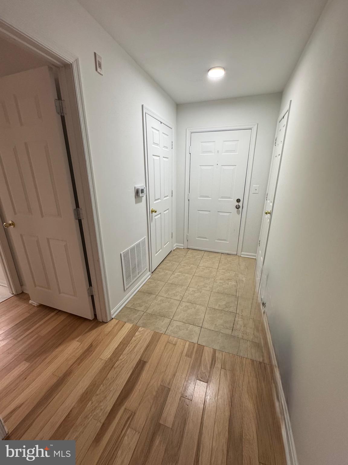 18310 Feathertree Way, Unit 101 Montgomery Village, MD 20886 - Photo 8 of 31 a view of hallway with wooden floor