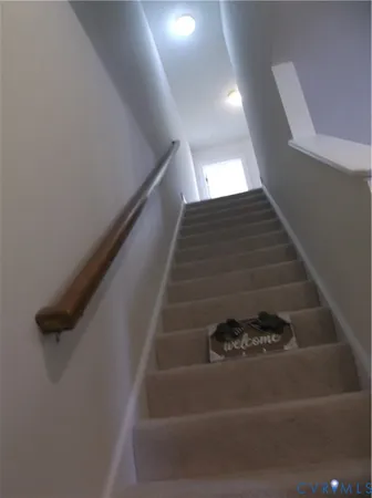 an empty room with windows and chandelier fan