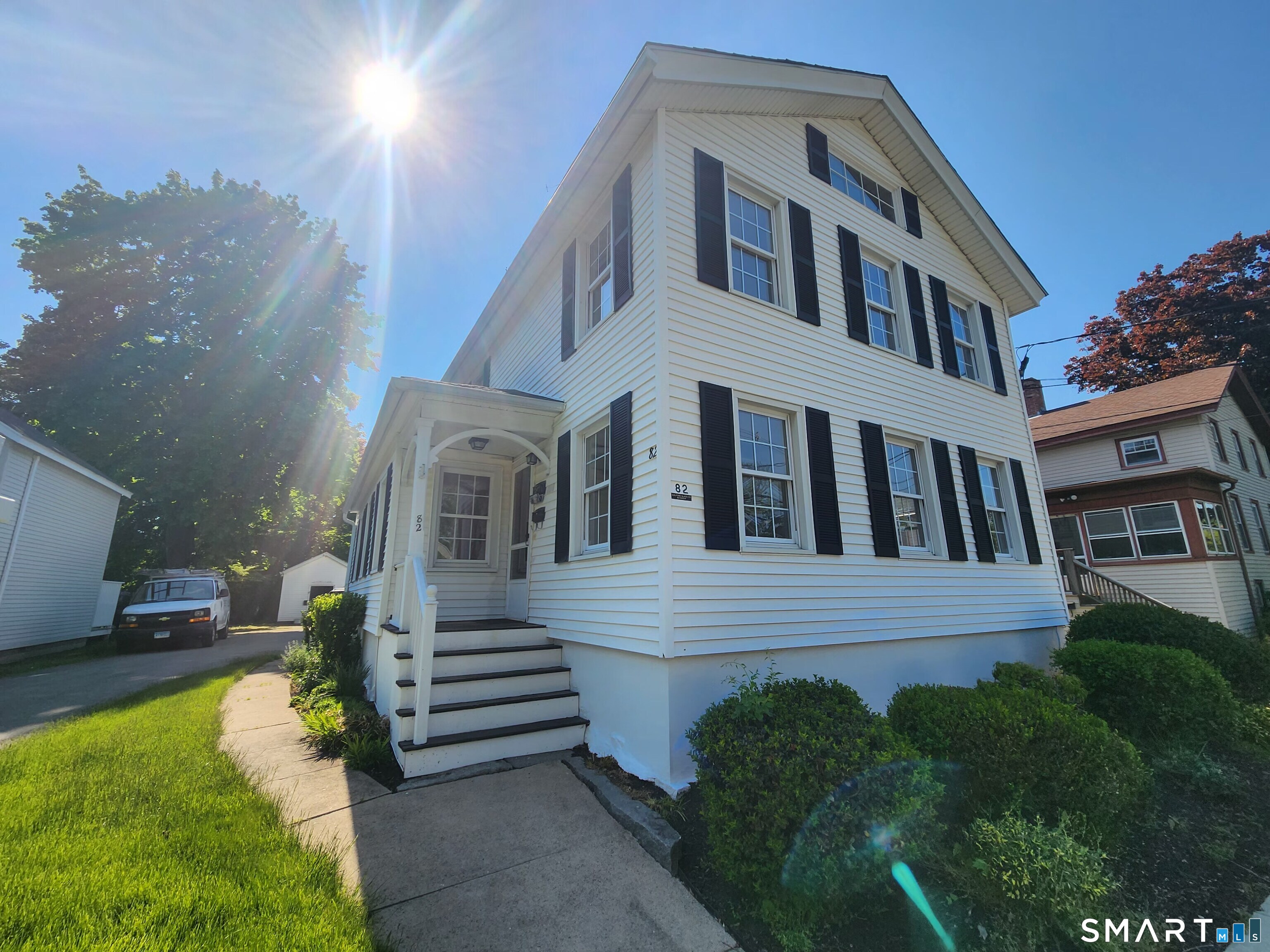 82 State Street, Unit 1 Guilford, CT 06437 - Photo 1 of 9 a front view of a house with a yard