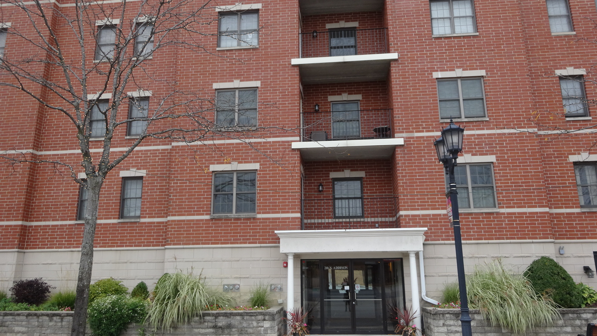 210 North Addison Avenue, Unit 401 Elmhurst, IL 60126 - Photo 2 of 30 a front view of a building with plants