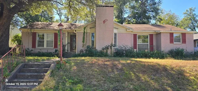 a front view of a house with a yard and porch