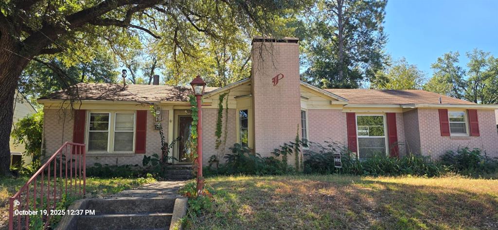 1314 South Azalea Drive Tyler, TX 75701 - Photo 2 of 27 a view of a house with brick walls and a yard with plants